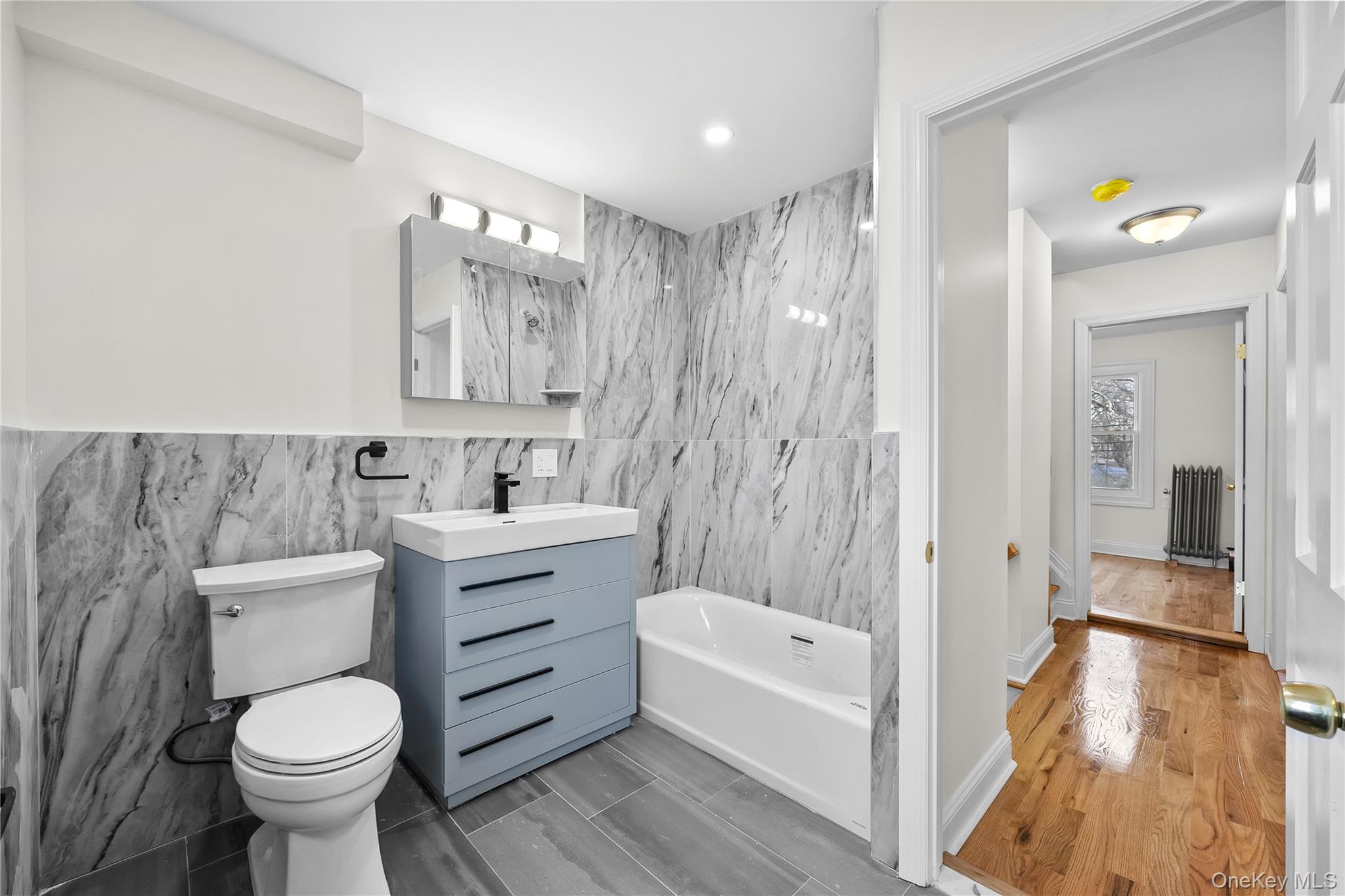 115-12 197th Street Queens, NY 11412 - Photo 15 of 26 a bathroom with a sink toilet and shower