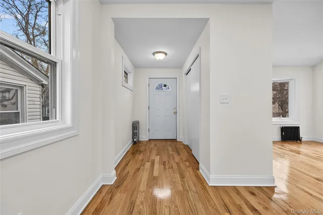 a view of a bedroom with wooden floor and a ceiling fan