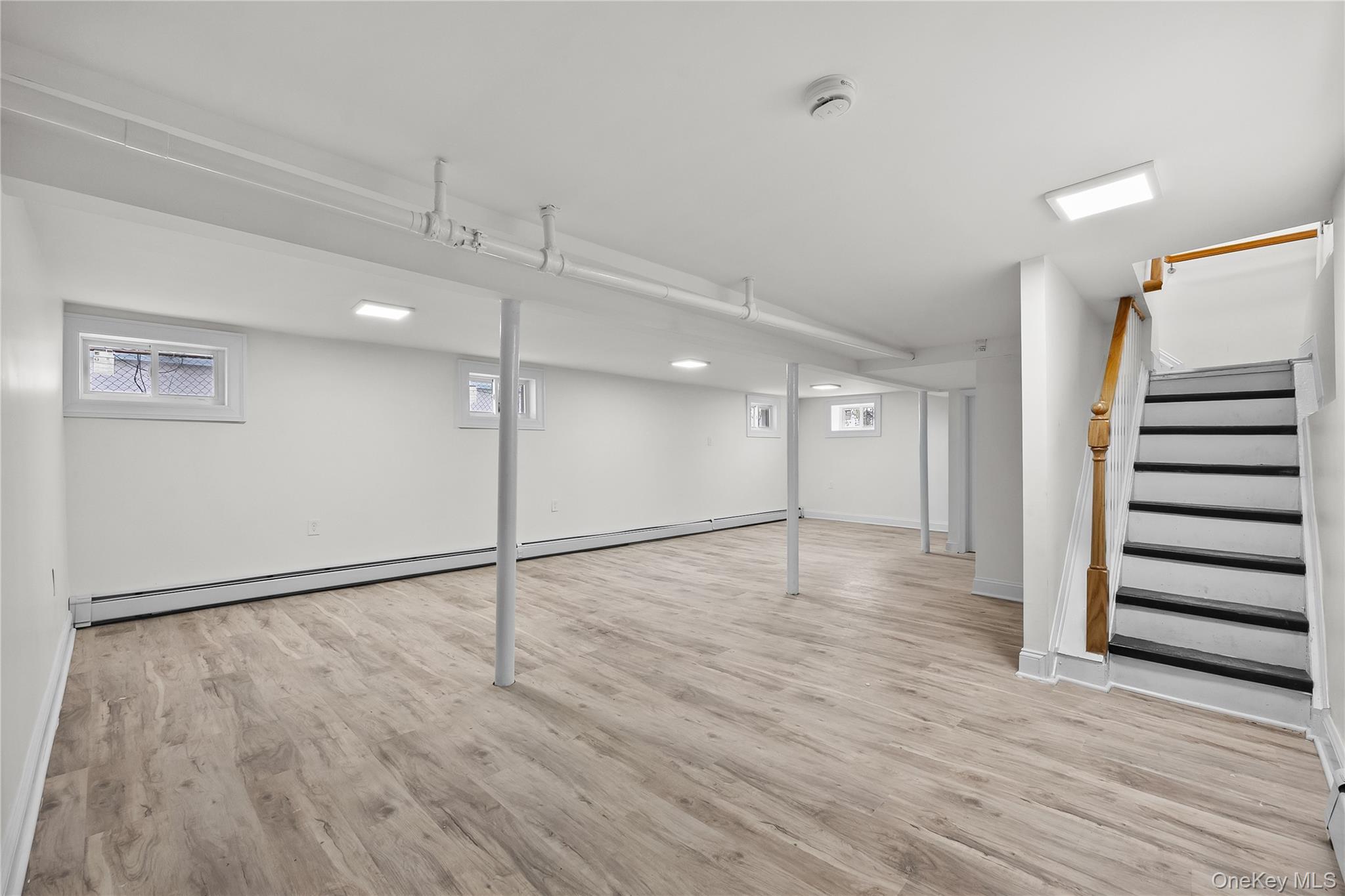 115-12 197th Street Queens, NY 11412 - Photo 21 of 26 a view of an empty room with wooden floor