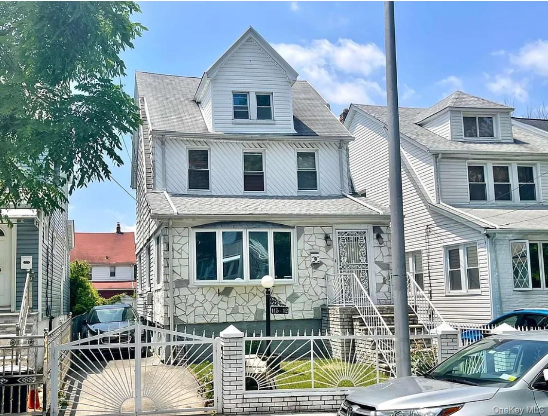 115-12 197th Street Queens, NY 11412 - Photo 23 of 26 a front view of a house with garden