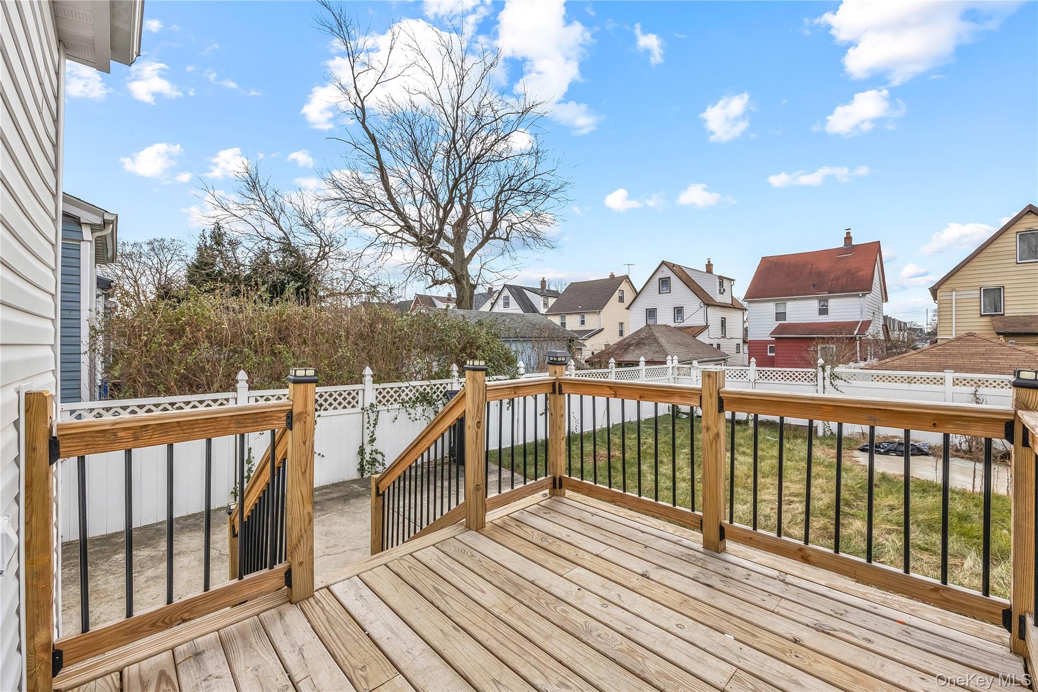 115-12 197th Street Queens, NY 11412 - Photo 26 of 26 a view of a balcony with wooden floor and fence