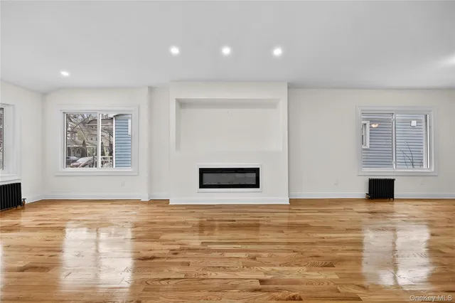 a view of an empty room with window and fireplace