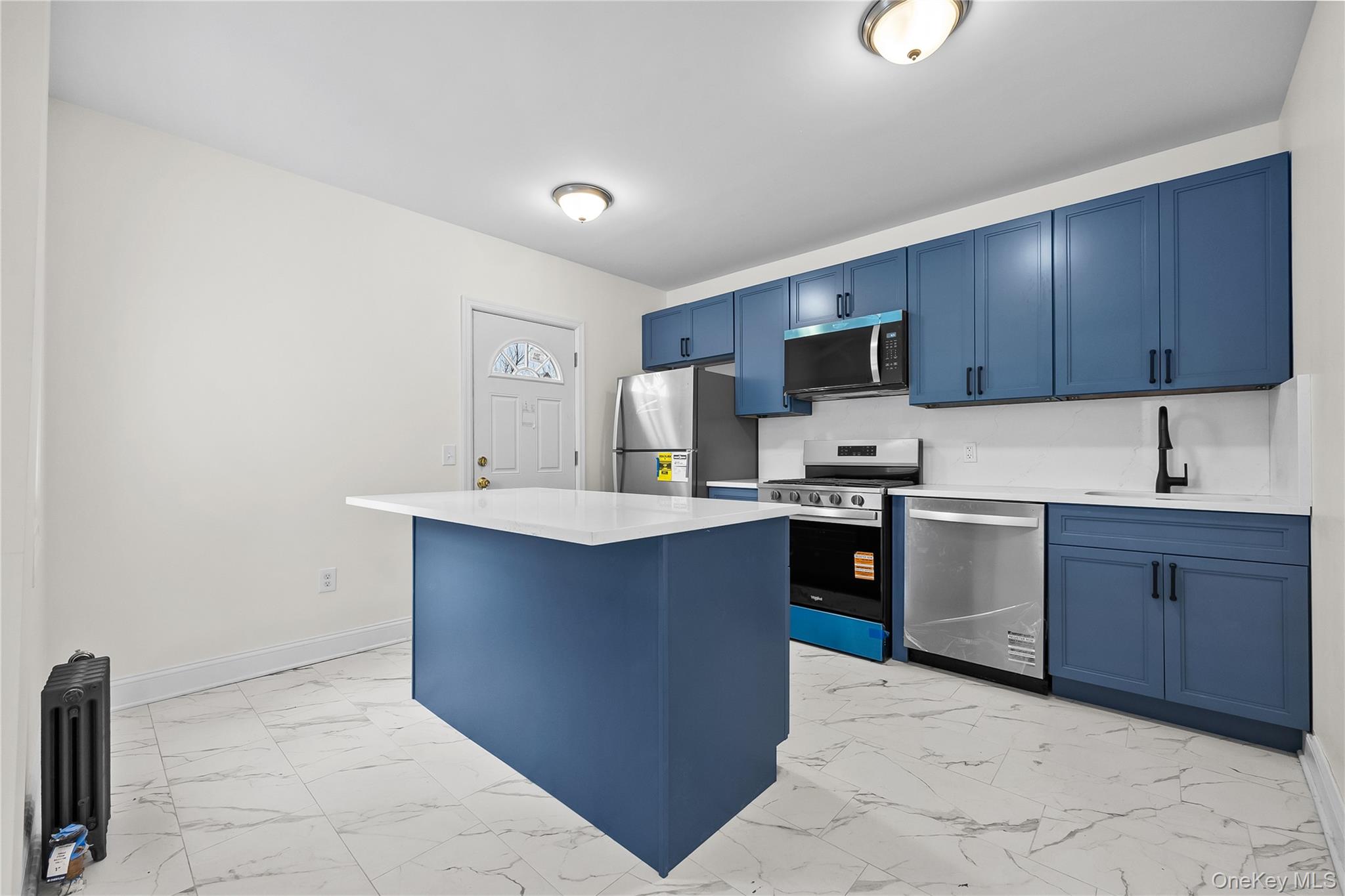 115-12 197th Street Queens, NY 11412 - Photo 9 of 26 a kitchen with wooden cabinets and a sink