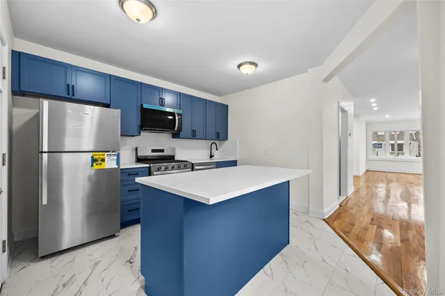 a kitchen with stainless steel appliances a refrigerator stove microwave and cabinets