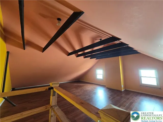 a view of a room with wooden floor