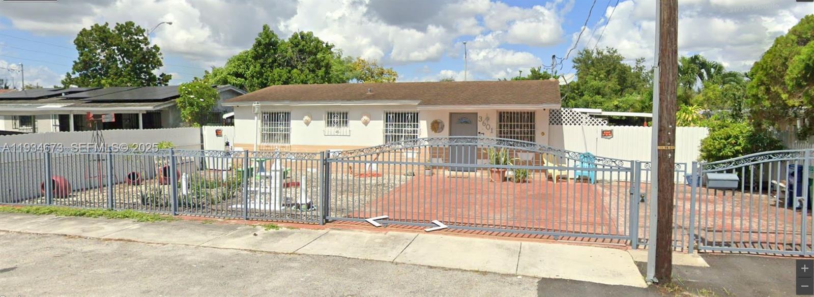 3601 Northwest 102nd Street Miami, FL 33147 - Photo 1 of 19 a view of a house with a backyard and a garage