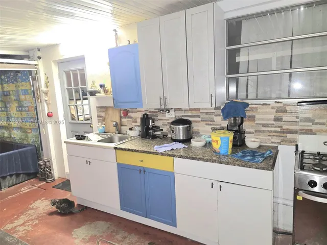 a kitchen with stainless steel appliances granite countertop a sink stove and cabinets