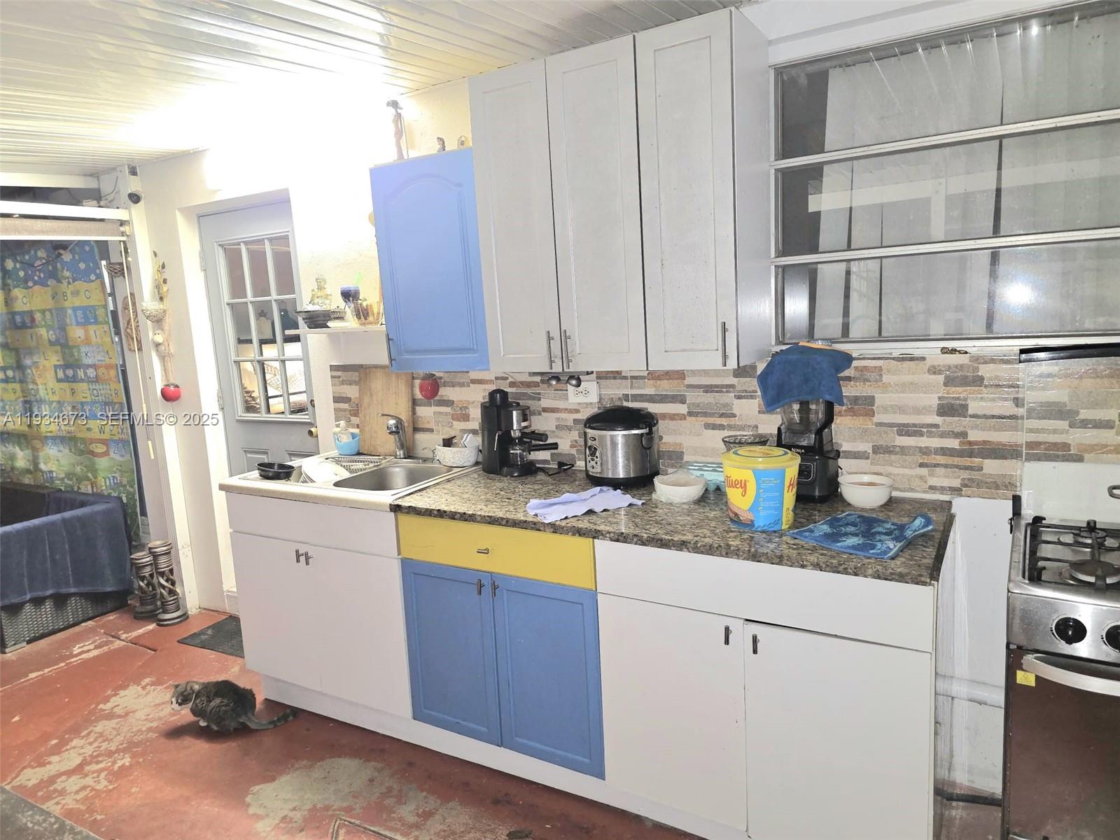 3601 Northwest 102nd Street Miami, FL 33147 - Photo 15 of 19 a kitchen with stainless steel appliances granite countertop a sink stove and cabinets