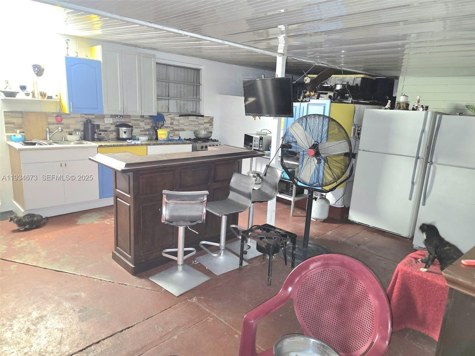 3601 Northwest 102nd Street Miami, FL 33147 - Photo 16 of 19 a living room with furniture a flat screen tv and a table