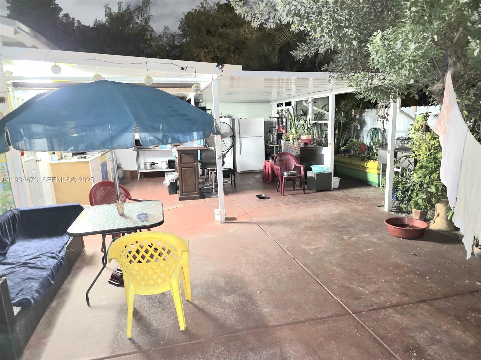 3601 Northwest 102nd Street Miami, FL 33147 - Photo 18 of 19 a view of a patio with table and chairs potted plants