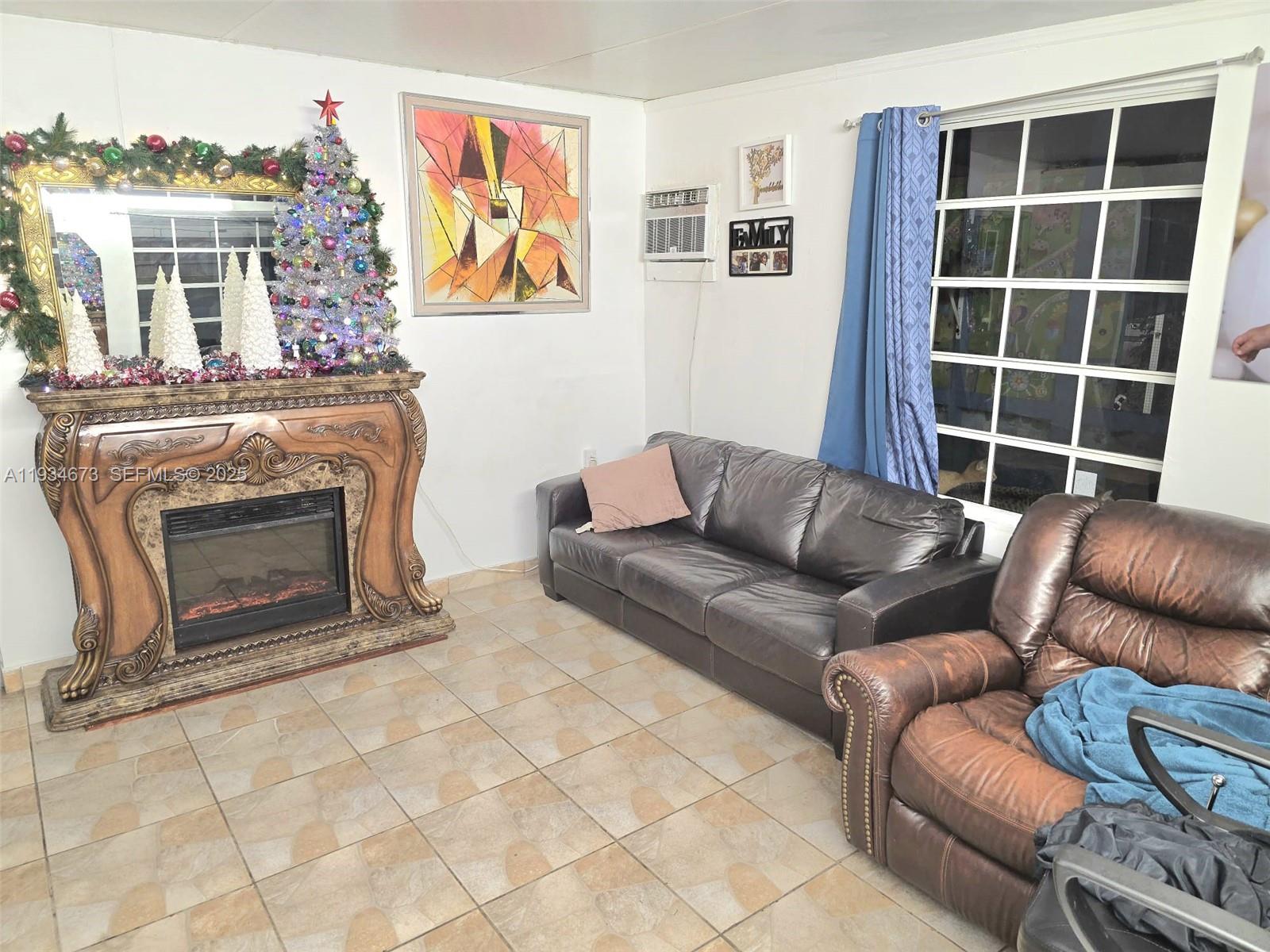 3601 Northwest 102nd Street Miami, FL 33147 - Photo 2 of 19 a living room with furniture a window and a fireplace