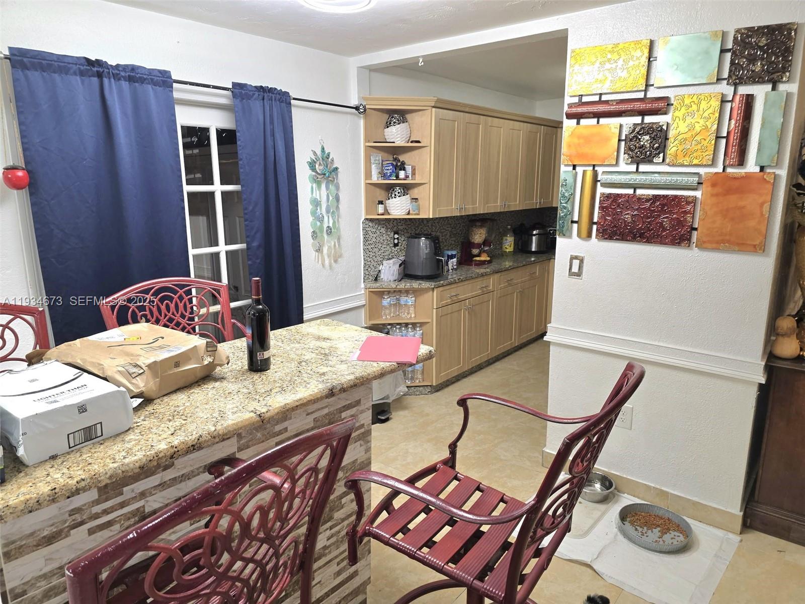 3601 Northwest 102nd Street Miami, FL 33147 - Photo 4 of 19 a living room with stainless steel appliances furniture a rug and a kitchen view