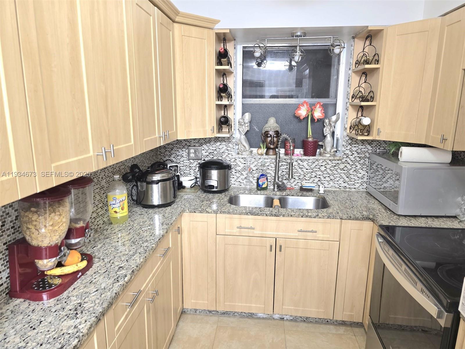 3601 Northwest 102nd Street Miami, FL 33147 - Photo 5 of 19 a kitchen with stainless steel appliances granite countertop a sink stove and cabinets