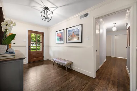 a view of a livingroom with wooden floor and a window