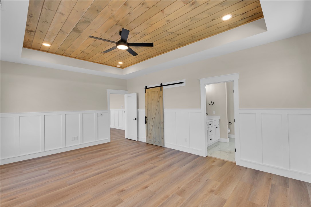 2816 Smith McGee Road Iva, SC 29655 - Photo 15 of 25 A spacious bedroom features a stylish wooden ceiling with recessed lighting and a ceiling fan, complemented by sleek flooring.