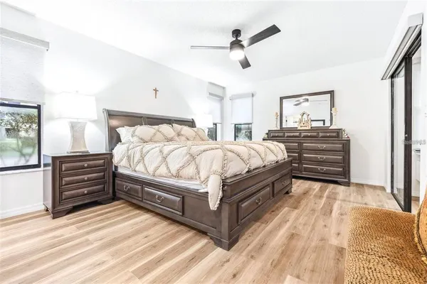 a bedroom with a bed and ceiling fan