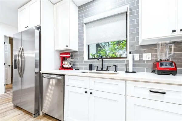 a kitchen with stainless steel appliances a sink and a window