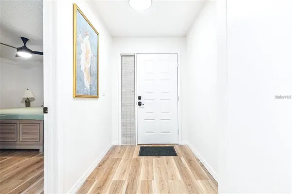 a view of a bedroom with wooden floor and windows