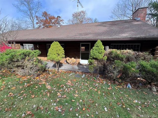 a backyard of a house with table and chairs