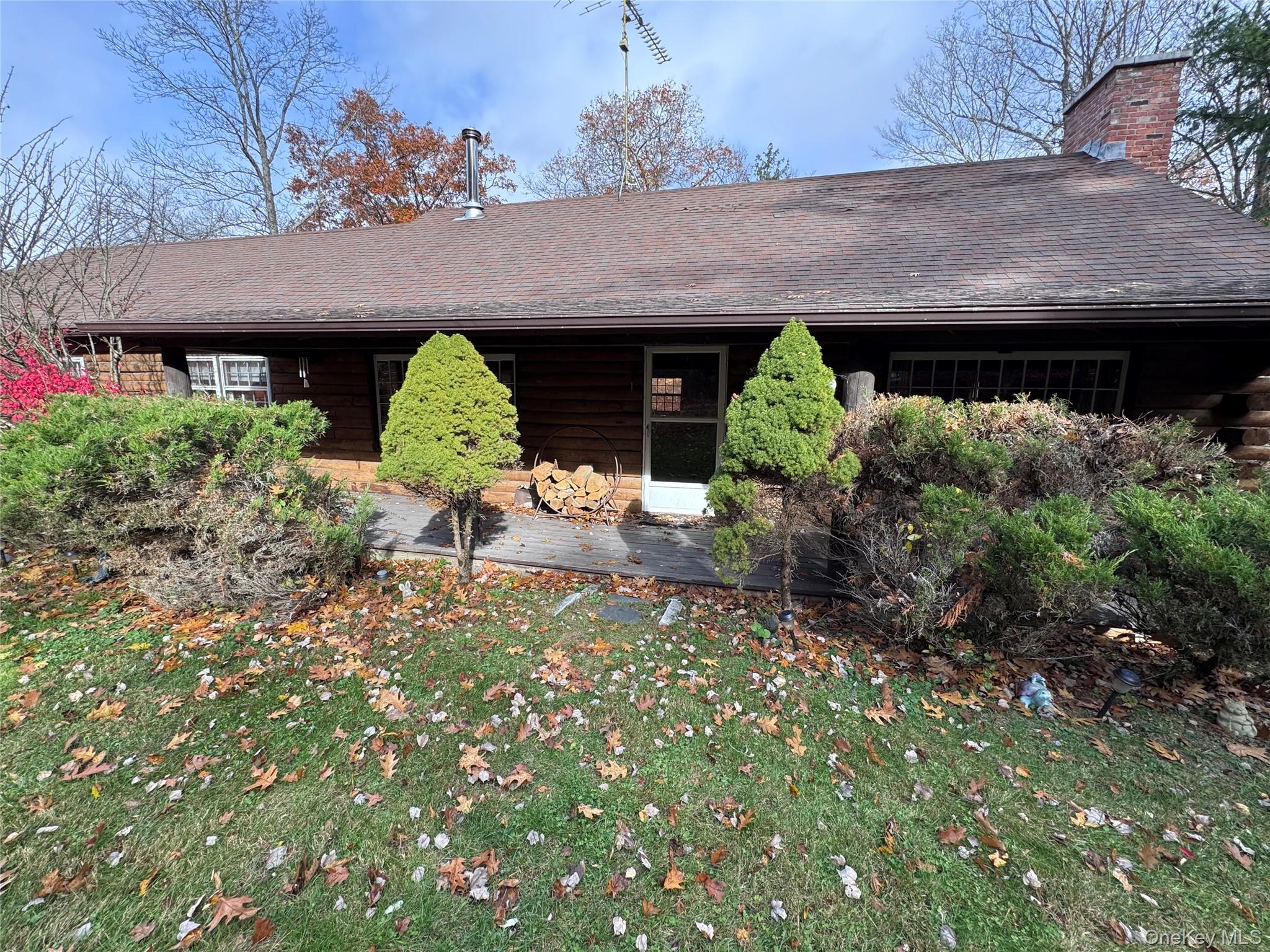 a backyard of a house with table and chairs