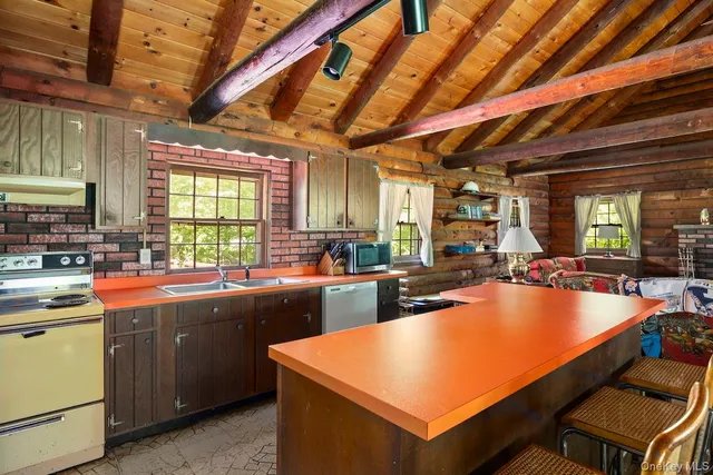 a kitchen with lots of counter top space and stainless steel appliances
