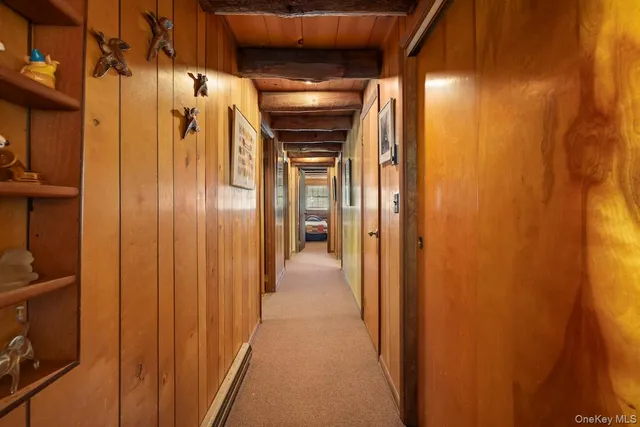 a view of a hallway with wooden shelves
