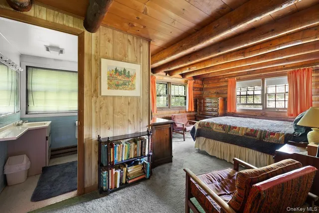 a bedroom with furniture and a window