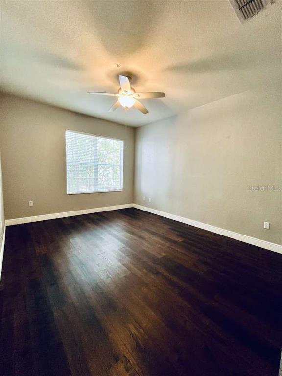 3311 Whitestone Circle, Unit 206 Kissimmee, FL 34741 - Photo 15 of 26 a view of a room with wooden floor and windows