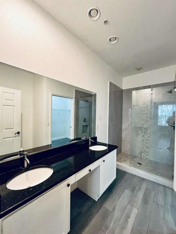 3311 Whitestone Circle, Unit 206 Kissimmee, FL 34741 - Photo 17 of 26 a large bathroom with a double vanity sink and a mirror