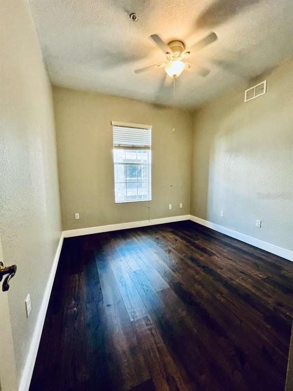 3311 Whitestone Circle, Unit 206 Kissimmee, FL 34741 - Photo 23 of 26 an empty room with wooden floor and windows