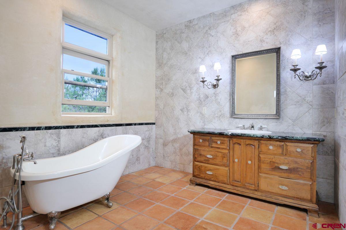78300 Hunters Ridge Lane Crawford, CO 81415 - Photo 11 of 32 a bathroom with a bathtub sink and toilet