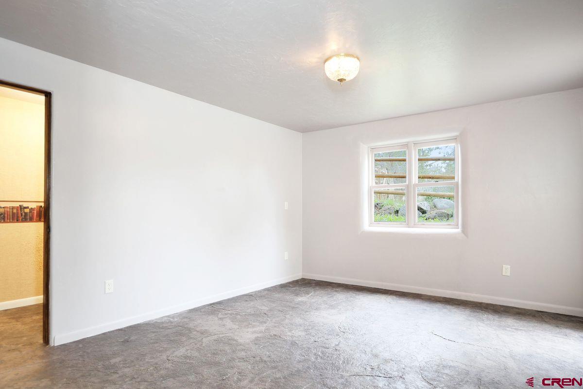 78300 Hunters Ridge Lane Crawford, CO 81415 - Photo 14 of 32 an empty room with windows
