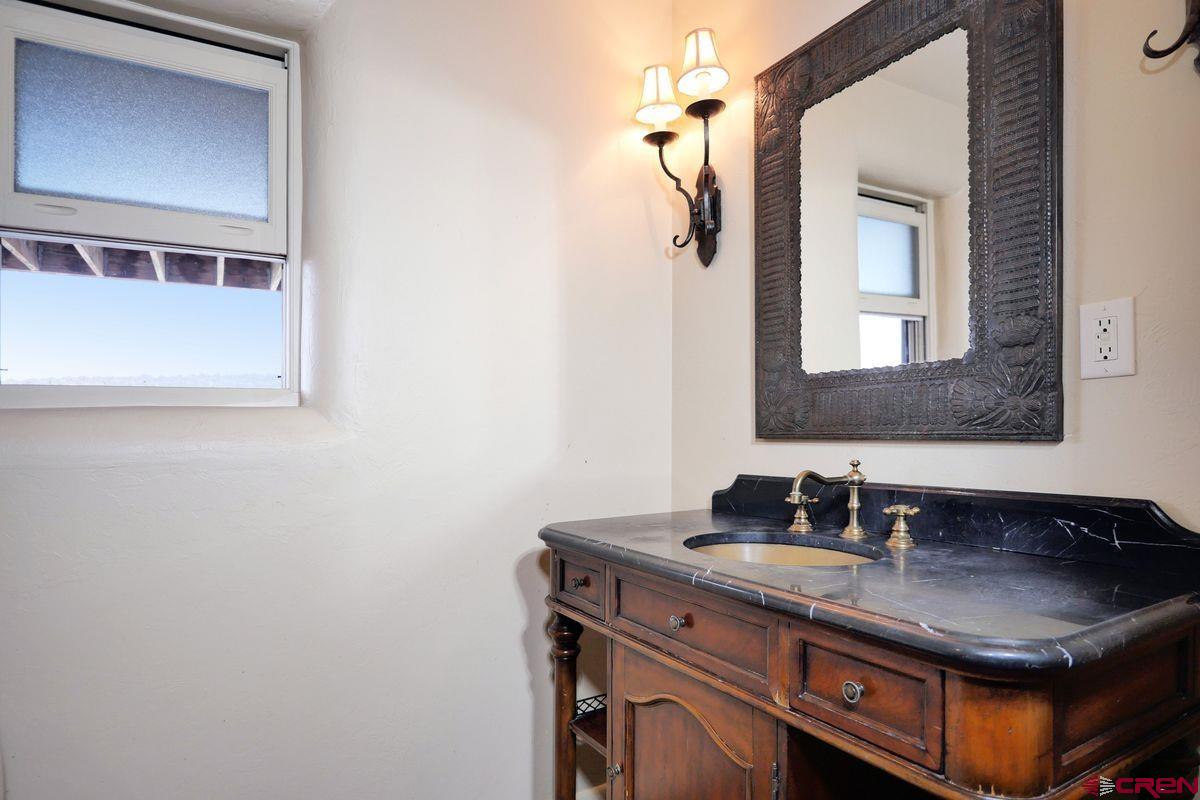 78300 Hunters Ridge Lane Crawford, CO 81415 - Photo 16 of 32 a bathroom with a sink and a mirror