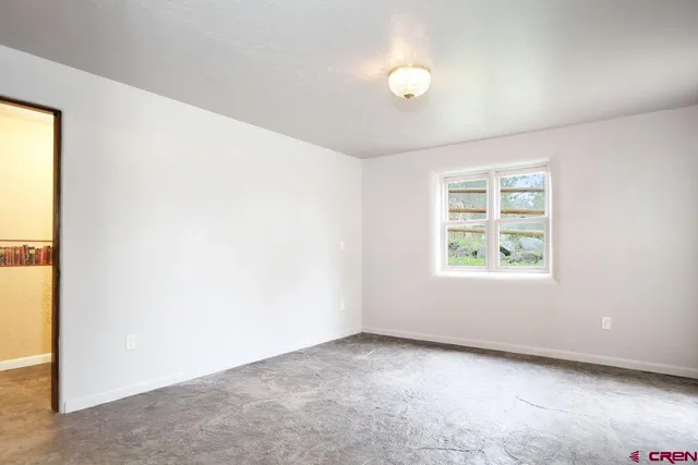 a view of a livingroom with a flat screen tv and windows