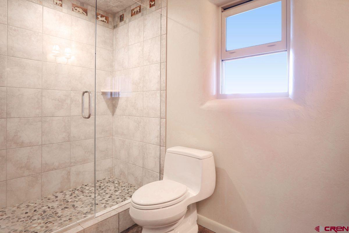 78300 Hunters Ridge Lane Crawford, CO 81415 - Photo 17 of 32 a white toilet sitting next to a shower