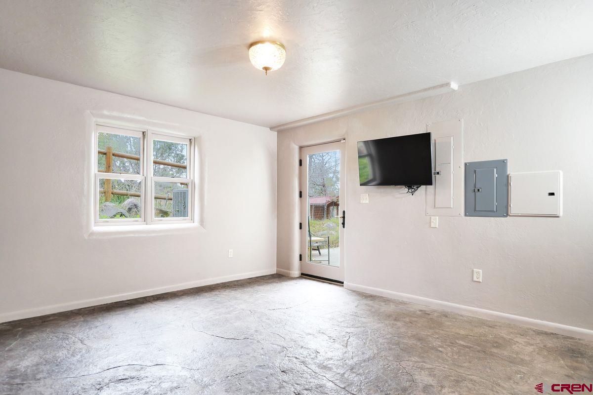 78300 Hunters Ridge Lane Crawford, CO 81415 - Photo 19 of 32 a view of a livingroom with a flat screen tv and windows