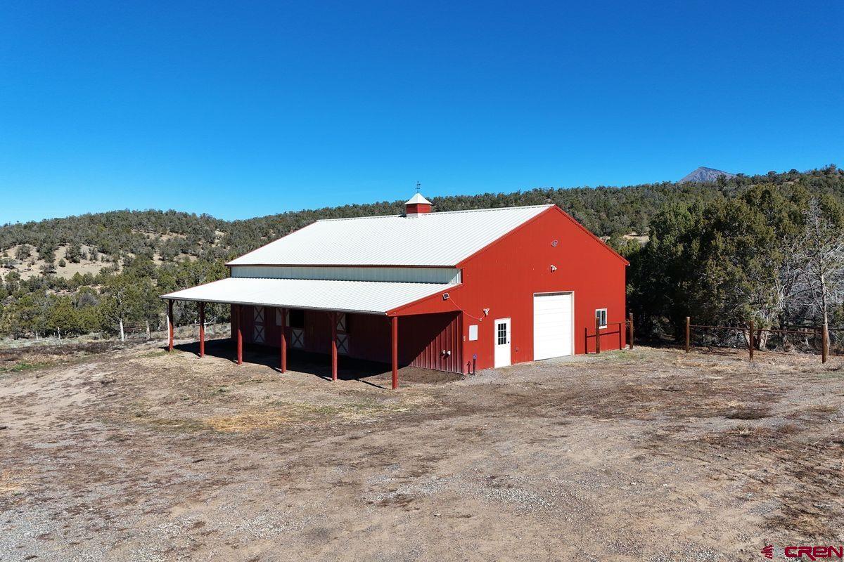 78300 Hunters Ridge Lane Crawford, CO 81415 - Photo 23 of 32 a front view of a house with a yard