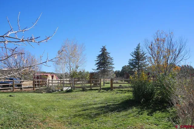 a view of a house with backyard porch and sitting area