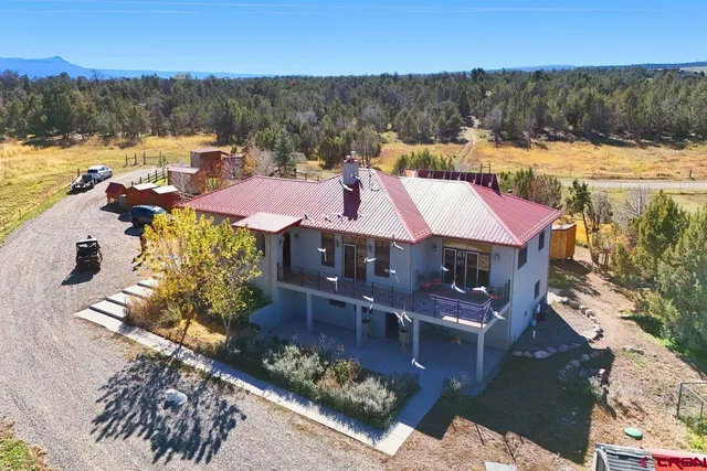 a view of a house with a yard from a balcony