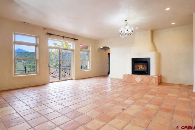 a view of a hallway with a chandelier and fireplace