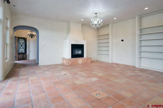 a large kitchen with stainless steel appliances a stove a sink and a refrigerator