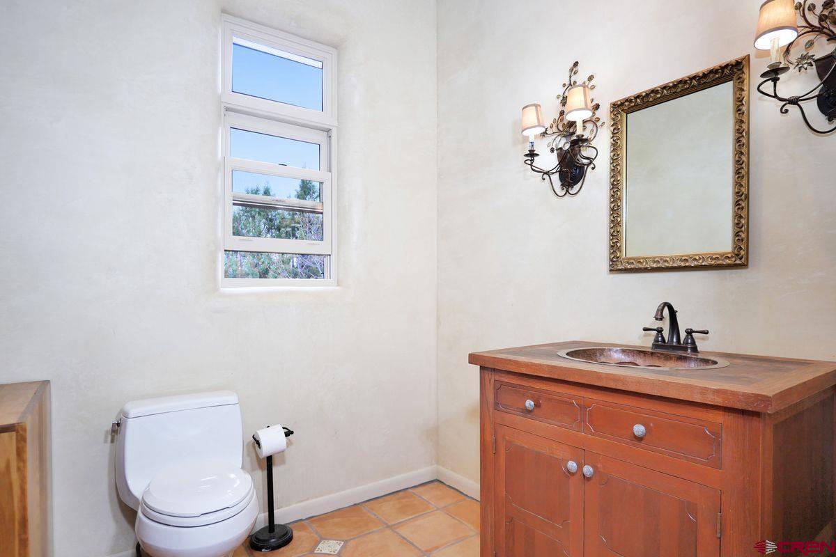 78300 Hunters Ridge Lane Crawford, CO 81415 - Photo 9 of 32 a bathroom with a toilet sink and mirror