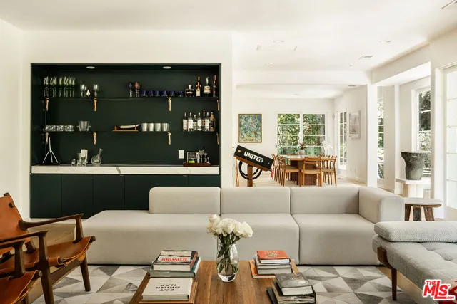 a living room with furniture and floor to ceiling windows