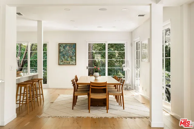 a dining room with furniture a rug and wooden floor
