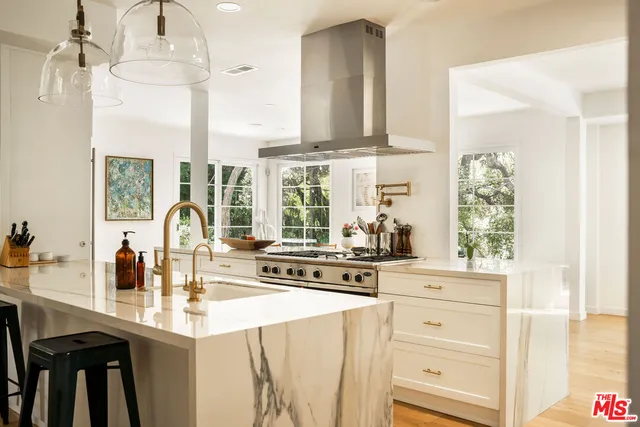 a kitchen with appliances cabinets and a large window