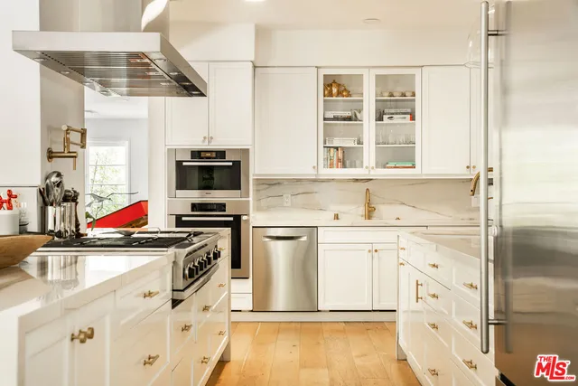 a kitchen with stainless steel appliances a stove sink and refrigerator