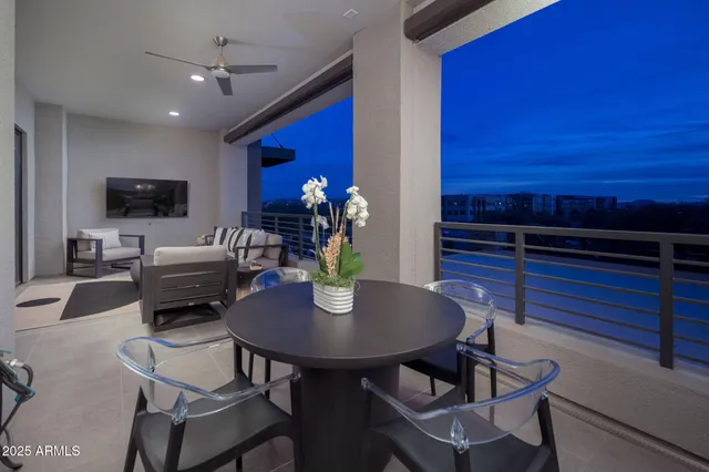 a living room with couches and kitchen view