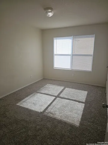 an empty room with a empty space and windows