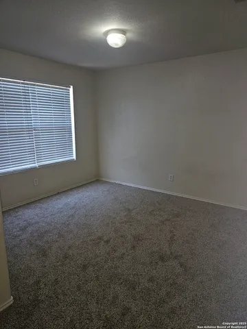 an empty room with a empty space and windows