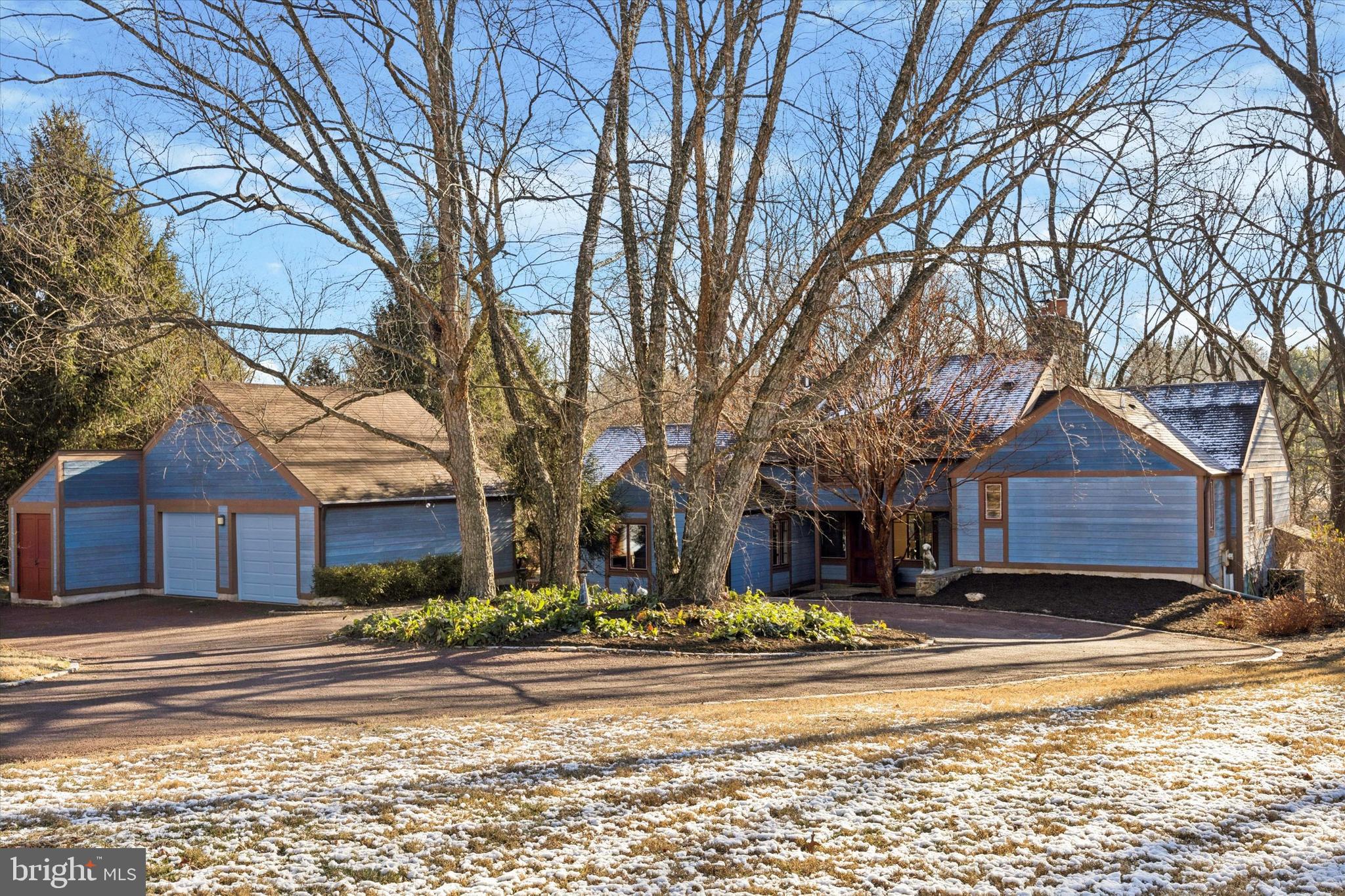 a view of a house with a yard covered with snow